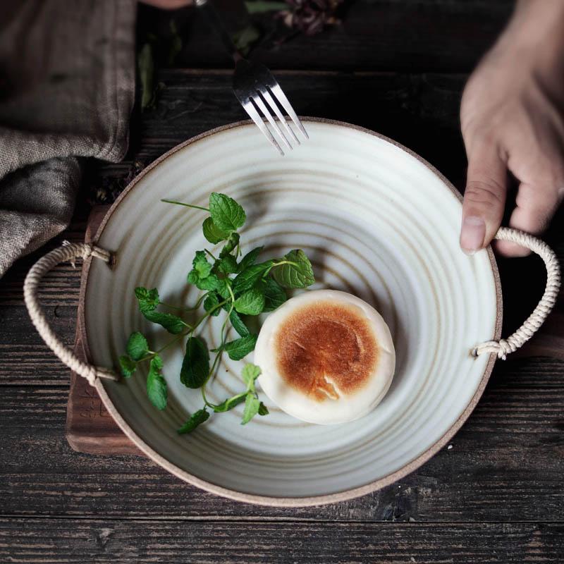 Hand-made Japanese Style Plates And Bowls with ceramic finish and rope handles, featuring a round salad plate on a wooden table.