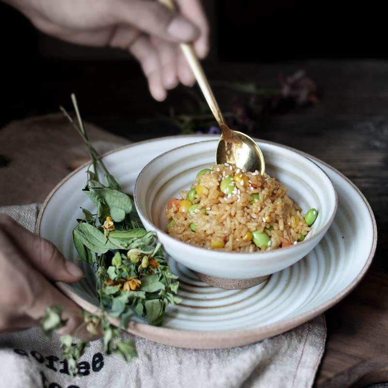 Hand-made Japanese Style Plates And Bowls with artistic ceramic design, perfect for salads and seafood, shown with a dish of rice and greens