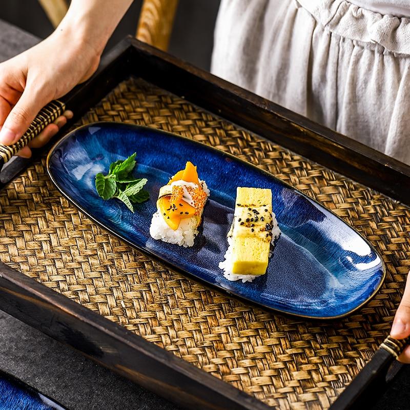 Serving sushi on an Eye Of Ocean Japanese Glazed Blue Long Plate with intricate design.