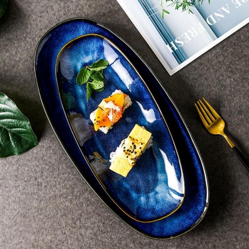 Elegant Eye Of Ocean Japanese Glazed Blue Long Plate with sushi, showcasing detailed craftsmanship and deep blue ceramic glaze.