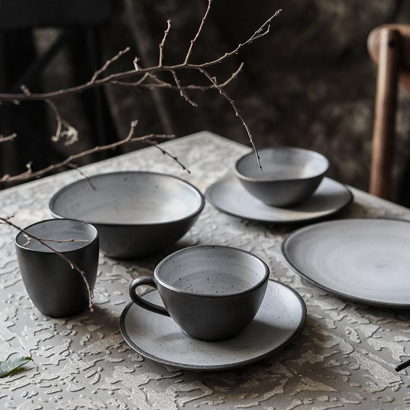Lena Nordic Style Steak Plate And Coffee Set made of handmade ceramic with a solid pattern, displayed on a textured table.