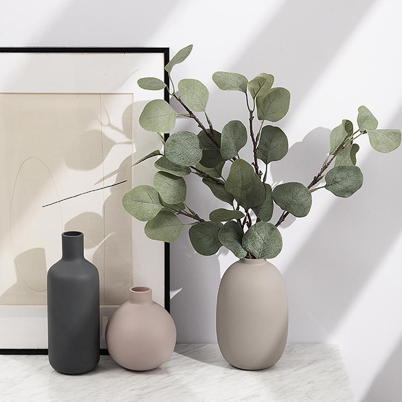 Modern Ceramic Vase with green foliage on a table, showcasing a sleek design perfect as a tabletop vase for contemporary decor.