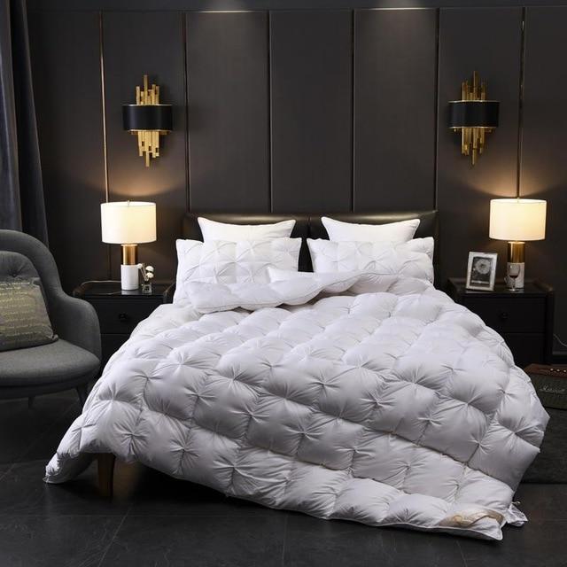 Luxury bedroom with Giuseppina 1000 Thread Count Goose Down Comforter Duvet on bed, elegant lighting and decor.