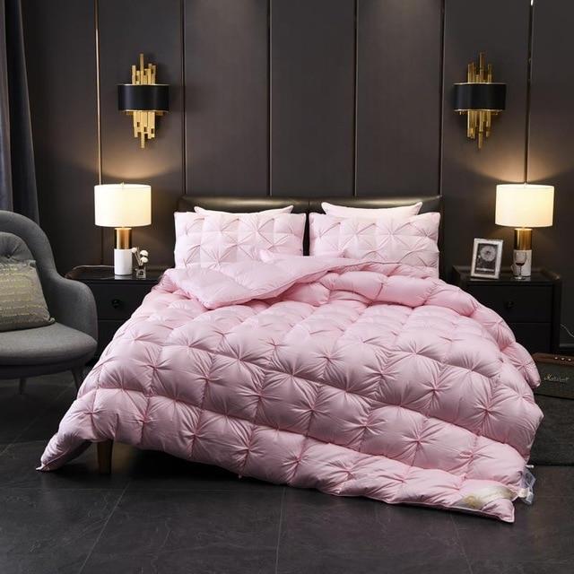 Luxurious Giuseppina 1000 Thread Count Goose Down Comforter Duvet in an elegant bedroom setting with soft lighting and decor.