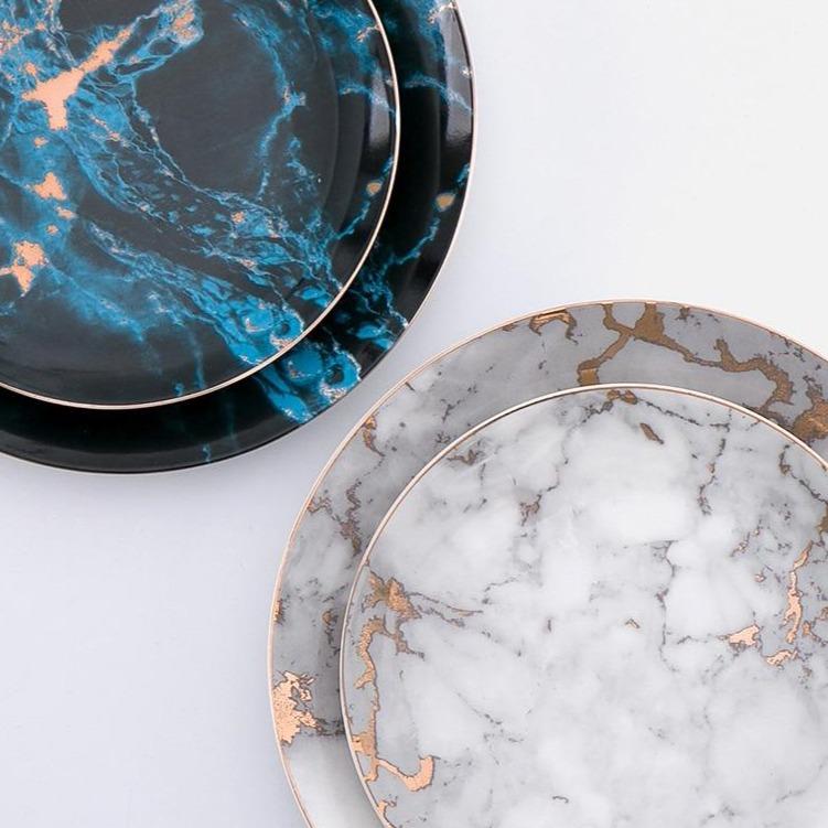 Selene Plates in black, blue, and light gray ceramic with strip pattern displayed on a table.