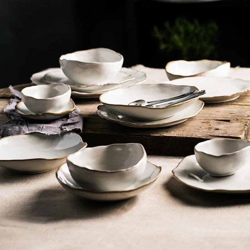 Elegant Nanna Bowls And Dishes from the Thetis Tableware Set displayed on a rustic wooden table, showcasing modern kitchen style.