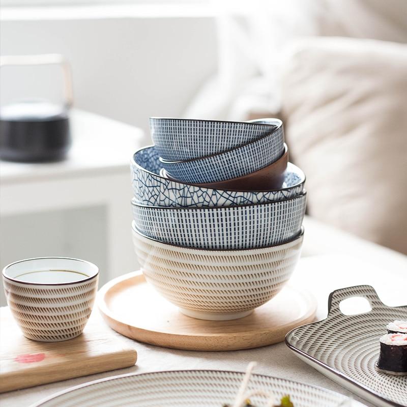 Modern Japanese Ceramic Bowls in various patterns, under glazed porcelain, eco-friendly and certified, stacked stylishly on a table.