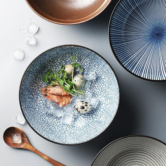 Modern Japanese Ceramic Bowls with intricate patterns, featuring under glazed porcelain; eco-friendly certified product displayed with food.