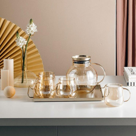 Luxury Nordic Drinking Set with eco-friendly transparent glassware on display, featuring round glasses and pitcher on a tray.