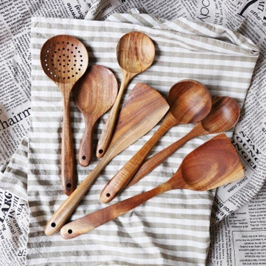 Modern Thailand Natural Teak Wood Utensils Set of 7 displayed on striped fabric
