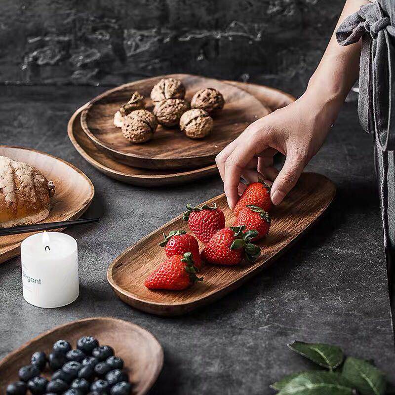 Serving strawberries on Mateo Oval Wood Board Set 5-Piece with other foods and candle on gray table