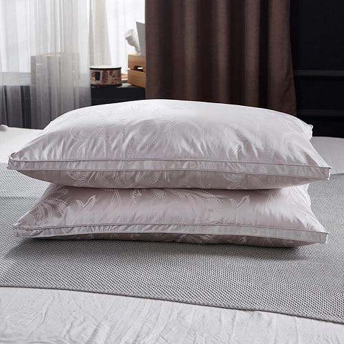 Vincenzo Pillows Set of 2 Goose Down on a bed, showcasing luxury and comfort.