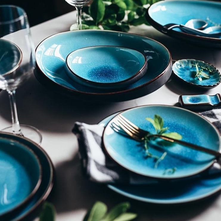 Elegant Rosmerta Bowls And Dishes in blue crackle glaze, Japan style porcelain, eco-friendly ceramic dinner set displayed on a table.