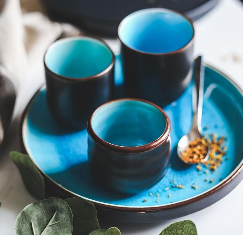 Rosmerta Bowls And Dishes, Japanese-style ceramic porcelain with crackle glaze, shown with spoons and solid pattern. Eco-friendly.