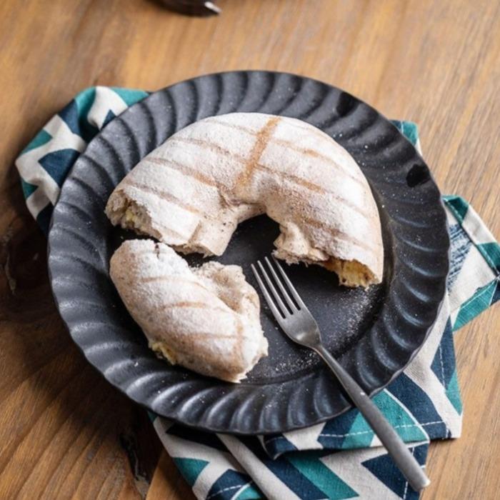 Ceto Nordic Plates showcasing a hand-made ceramic plate with bread and fork, highlighting Nordic inspiration in dining ware.