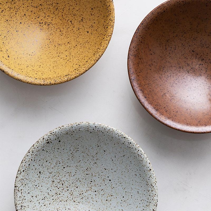 Top view of three ceramic bowls in earthy tones, showcasing the Hemera Ceramic Bowl range on a light surface.