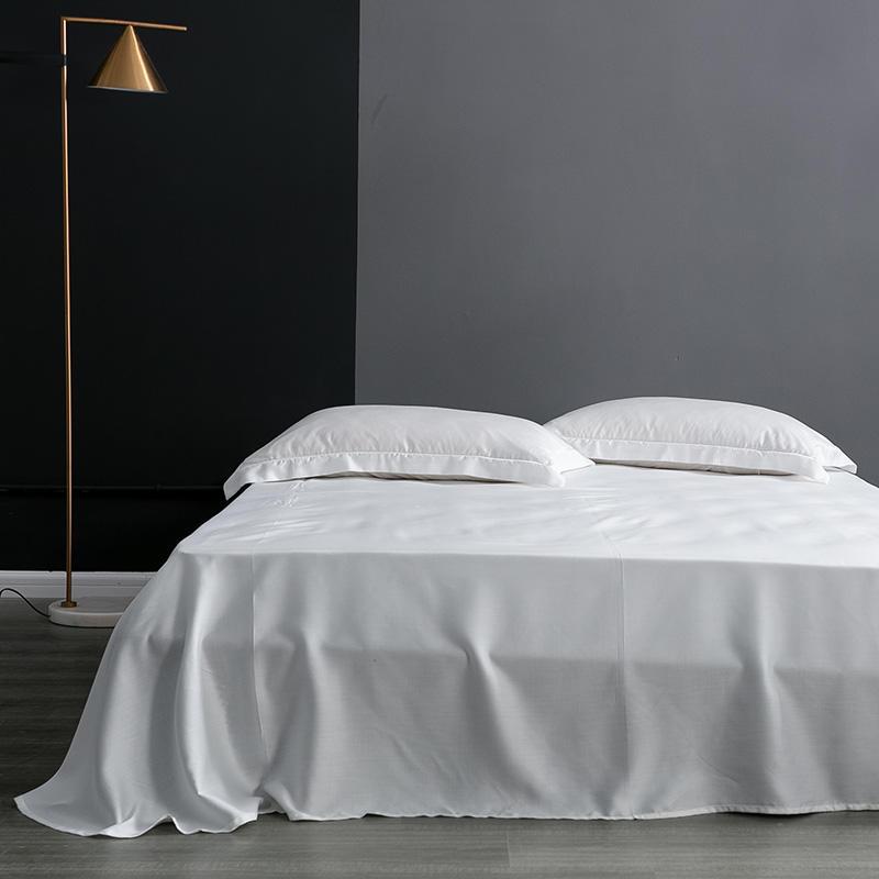 Karen Solid Color Lyocell Duvet Cover Set in white displayed on a bed with modern and boho style, showcasing its smooth Tencel Lyocell fabric.