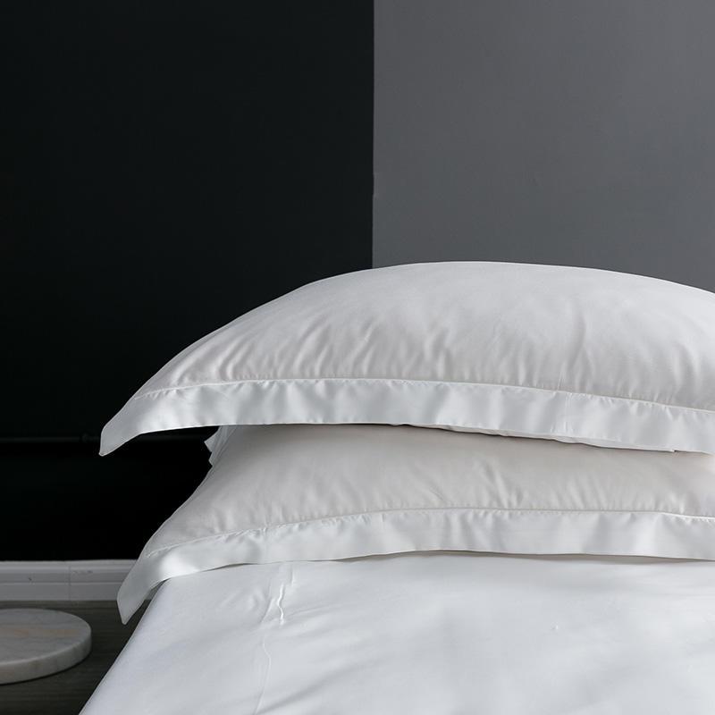 Karen Solid Color Lyocell Duvet Cover Set in white, featuring a modern boho style with soft touch, shown in a contemporary bedroom setting.