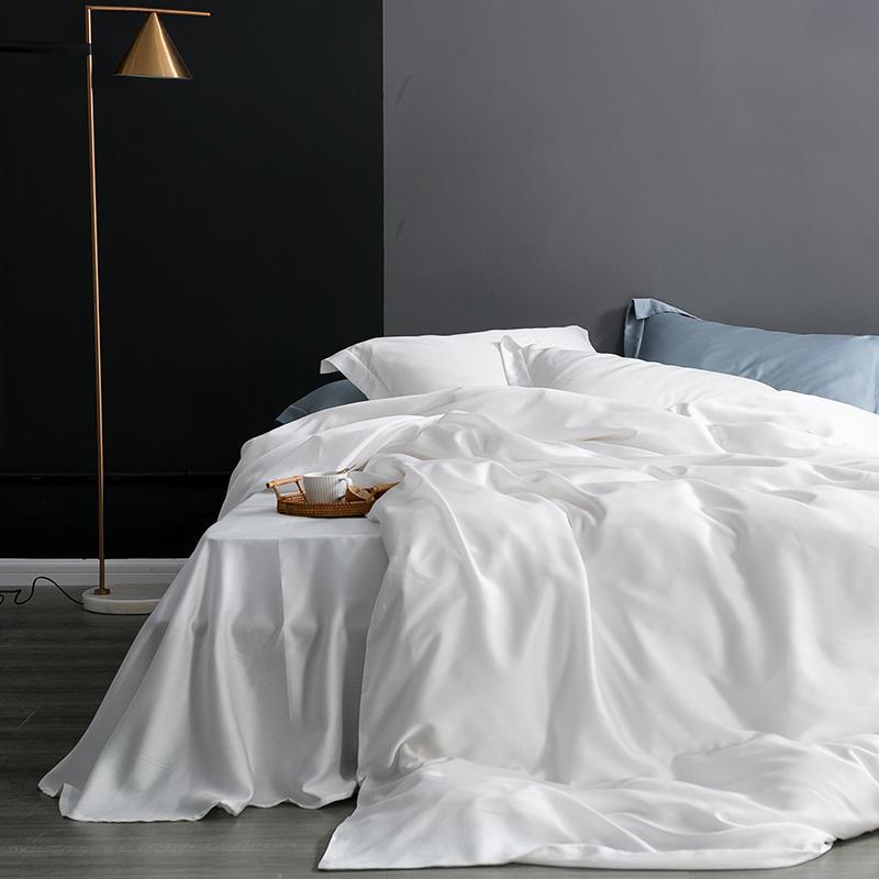 Karen Solid Color Lyocell Duvet Cover Set in white, featuring modern and boho style on a neatly made bed in a stylish bedroom setting.