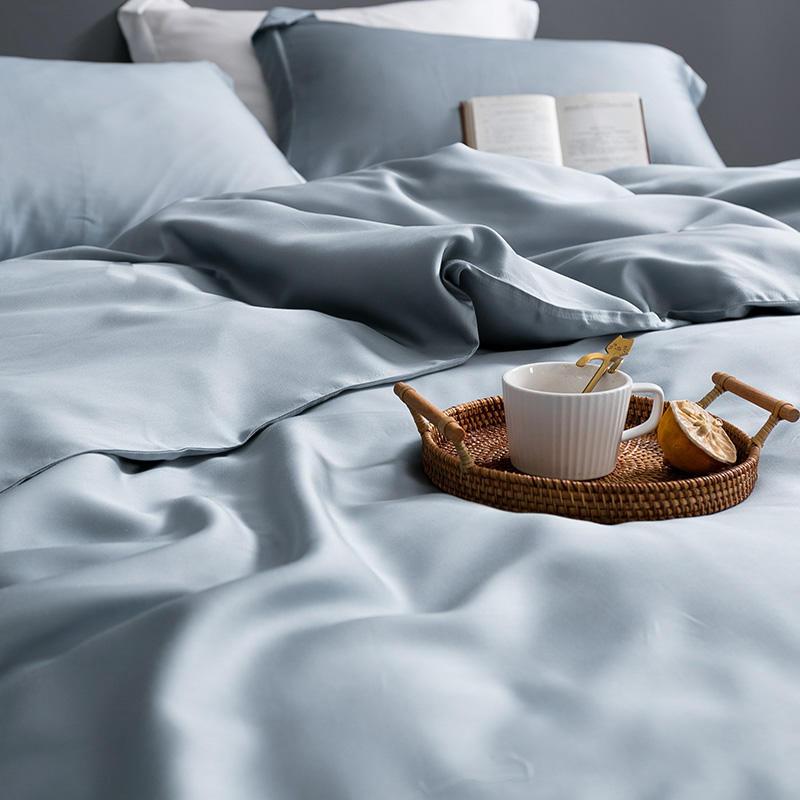 Karen Solid Color Lyocell Duvet Cover Set in blue, featuring a modern and boho style made of Tencel Lyocell, with a cup of tea on a tray