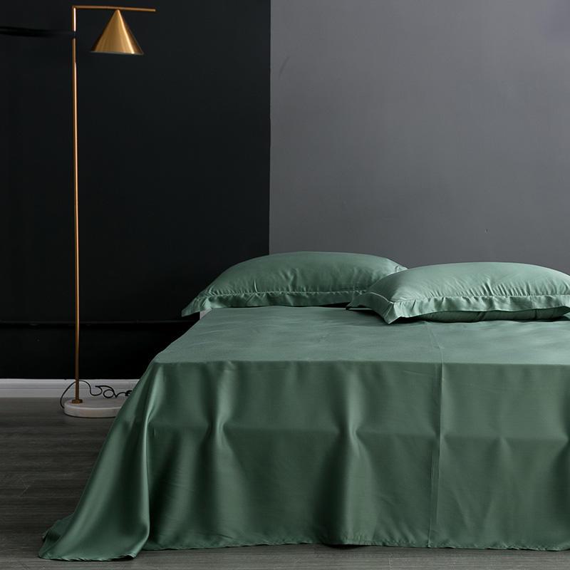 Karen Solid Color Lyocell Duvet Cover Set in green, modern boho style, made of Tencel Lyocell, displayed on bed with pillows.