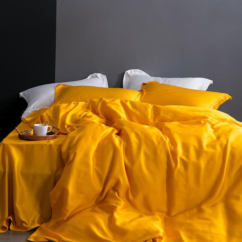 Karen Solid Color Lyocell Duvet Cover Set in vibrant yellow on a modern bed with white pillows, showcasing boho style and luxurious comfort.