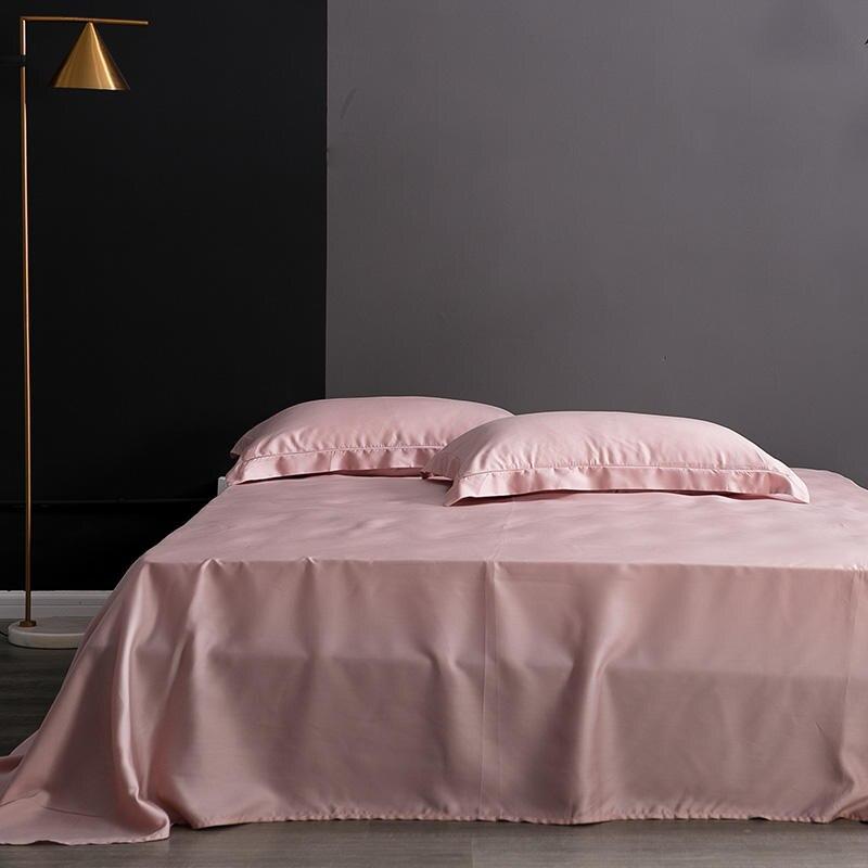 Karen Solid Color Lyocell Duvet Cover Set in pink on bed, featuring modern boho style, made from Tencel Lyocell, gains softness with each wash.