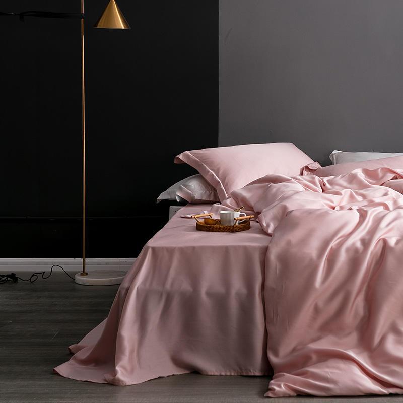 Karen Solid Color Lyocell Duvet Cover Set in pink displayed on a bed with modern boho styling, showcasing soft texture after washing.