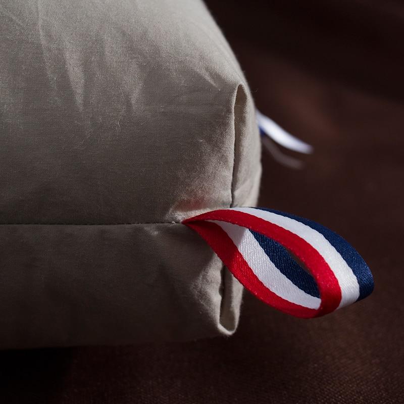 Close-up of Giovanni Goose Down Pillows Cotton Made Set of 2 with a corner design and red, white, blue ribbon decoration.