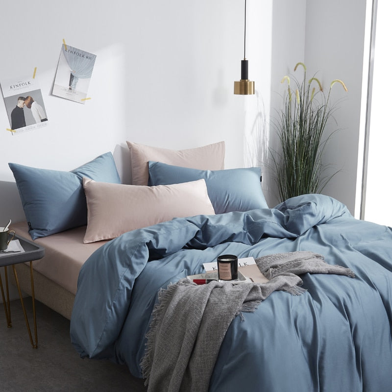 Zenith Grace Silk Duvet Cover Set (Premium Egyptian Cotton) 600TC on modern bed with blue and beige bedding, cozy ambiance.