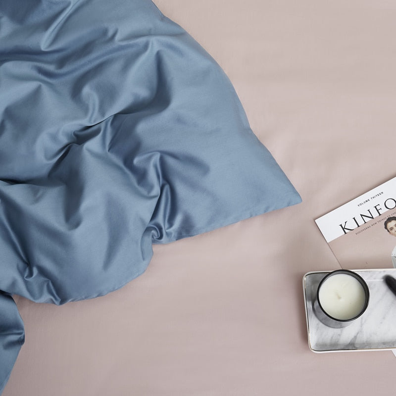 Zenith Grace Silk Duvet Cover Set (Premium Egyptian Cotton) 600TC in solid Zenith color, shown with a book and candle for bedroom ambiance.