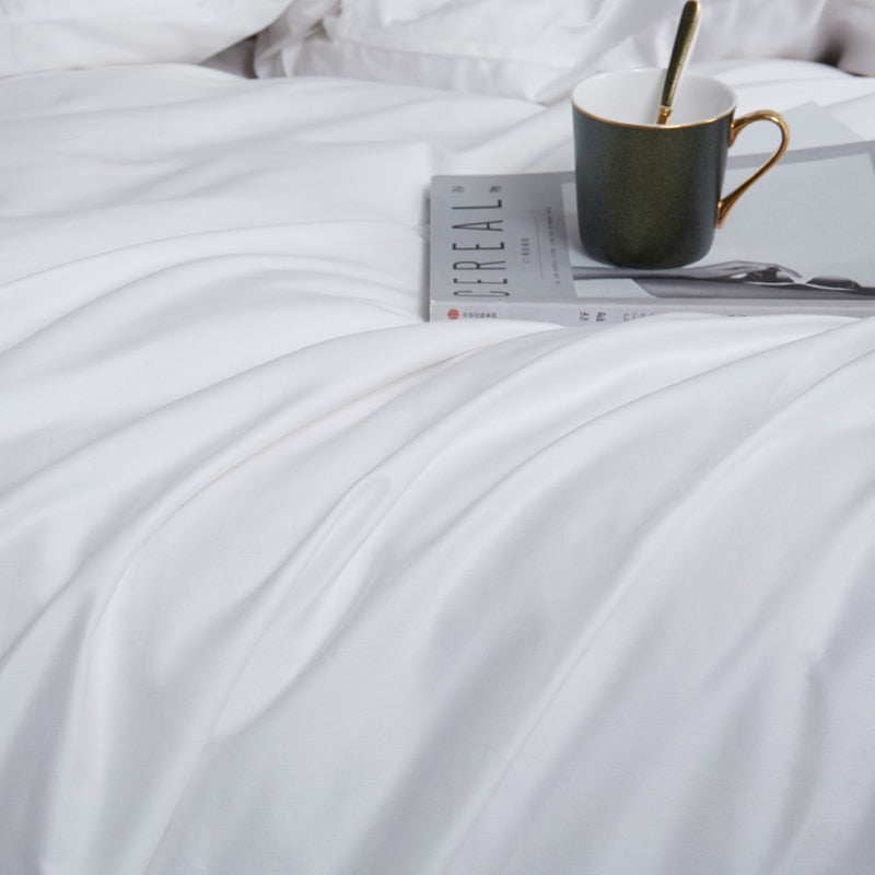 White Grace Silk Duvet Cover Set (Premium Egyptian Cotton) 600TC displayed on a bed with a magazine and a cup.