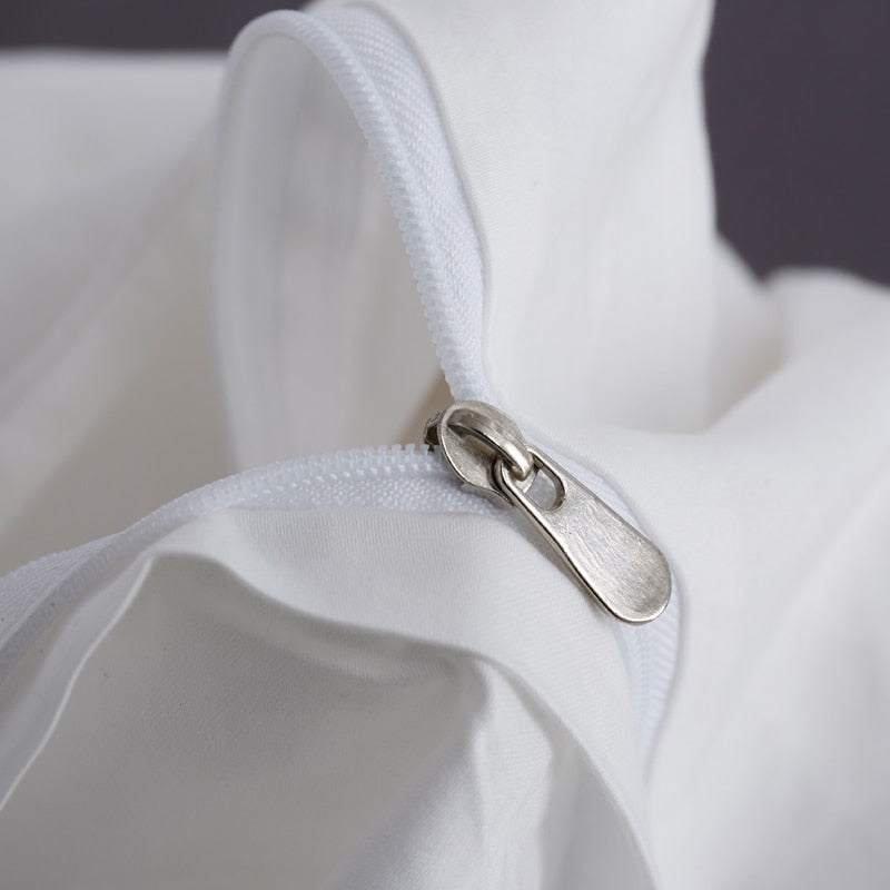 Close-up of zipper on White Grace Silk Duvet Cover Set (Premium Egyptian Cotton) 600TC, showcasing smooth fabric and design detail.