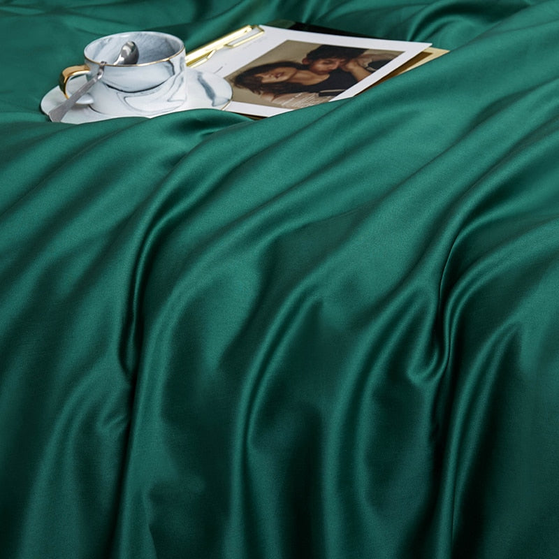 Luxurious Green Grace Silk Duvet Cover Set (Premium Egyptian Cotton) 600TC on display with a silver tea cup and photographs.