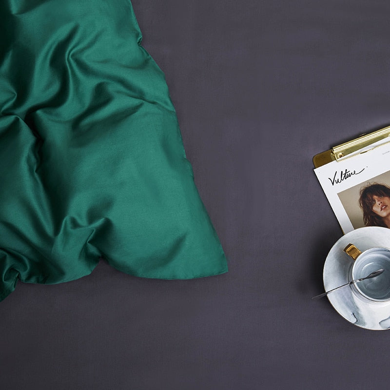 Green Grace Silk Duvet Cover Set (Premium Egyptian Cotton) 600TC displayed on a bed beside a magazine and coffee cup