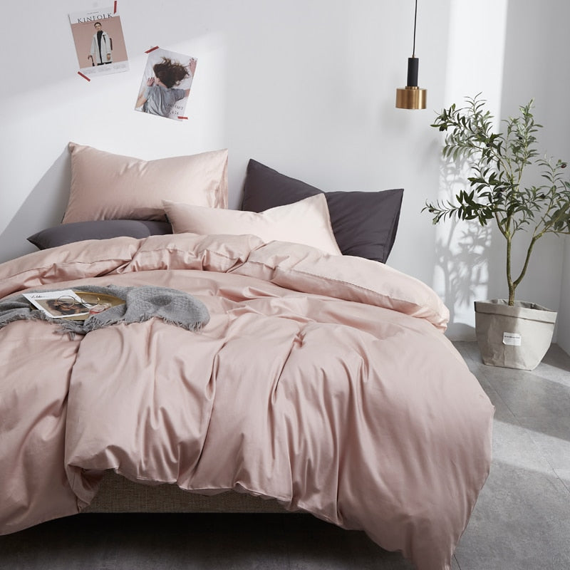 PeachPuff Grace Silk Duvet Cover Set (Premium Egyptian Cotton) 600TC displayed on a stylish bed setting with plants and magazines.