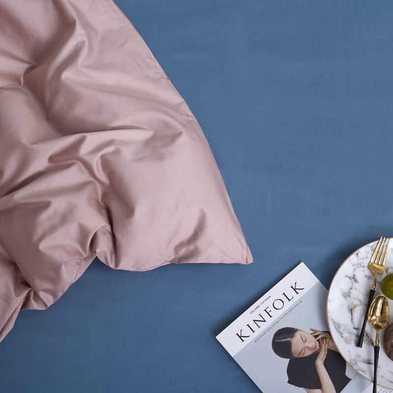 MistyRose Grace Silk Duvet Cover Set (Premium Egyptian Cotton) 600TC displayed on a bed with a magazine and plate on blue background