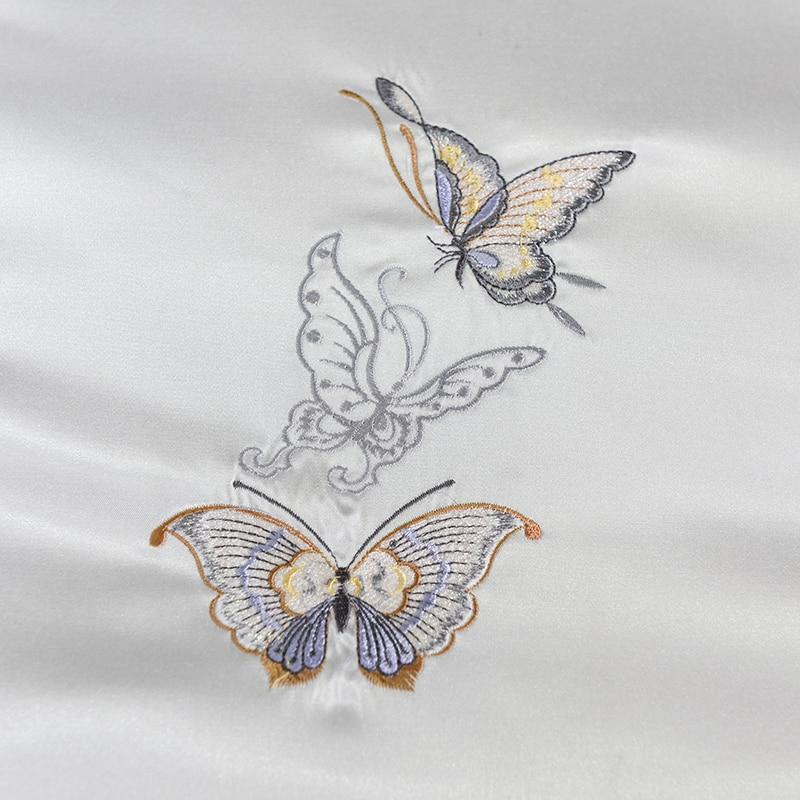 Embroidered butterflies on Platinum Butterfly Duvet Cover Set in satin and cotton fabric.