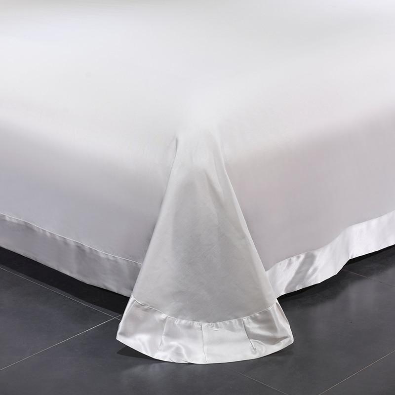 Minimalist satin and cotton duvet cover detail from the Platinum Butterfly Duvet Cover Set on a bed corner