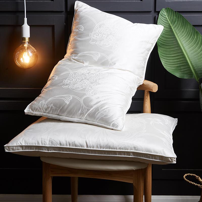Vincenzo Pillows Set of 2 Goose Down displayed on a chair, featuring intricate patterns, ideal for enhancing bedroom decor.
