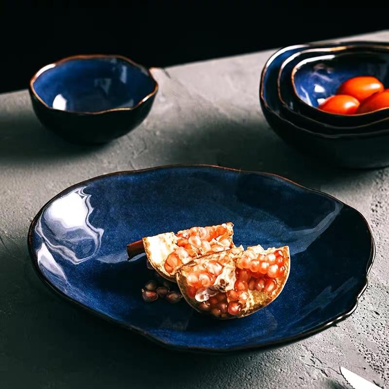 Blue European Porcelain Dinnerware Set (Plates and Bowls) featuring dark blue plates with fruit, enhancing dining elegance.