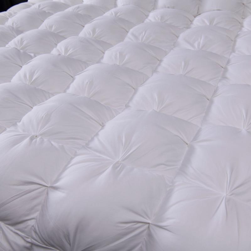 Close-up of Giuseppina 1000 Thread Count Goose Down Comforter Duvet showcasing luxury Egyptian cotton fabric and detailed tufting.