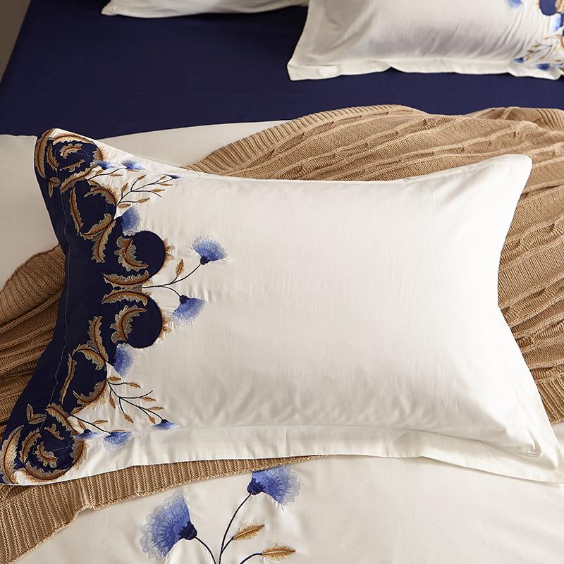 Blue Tail Luxury Duvet Cover Set (60S Egyptian Cotton) pillowcase with elegant white and blue floral embroidery, enhancing bedroom decor.