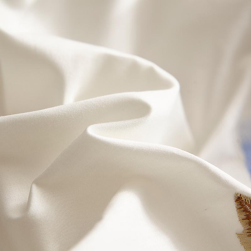 Close-up of Blue Tail Luxury Duvet Cover Set (60S Egyptian Cotton) showing soft and luxurious texture in white and blue fabric.