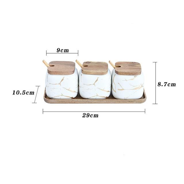 Maci 8-Piece Spice Ceramic Jar With Wooden Lid set on wooden tray