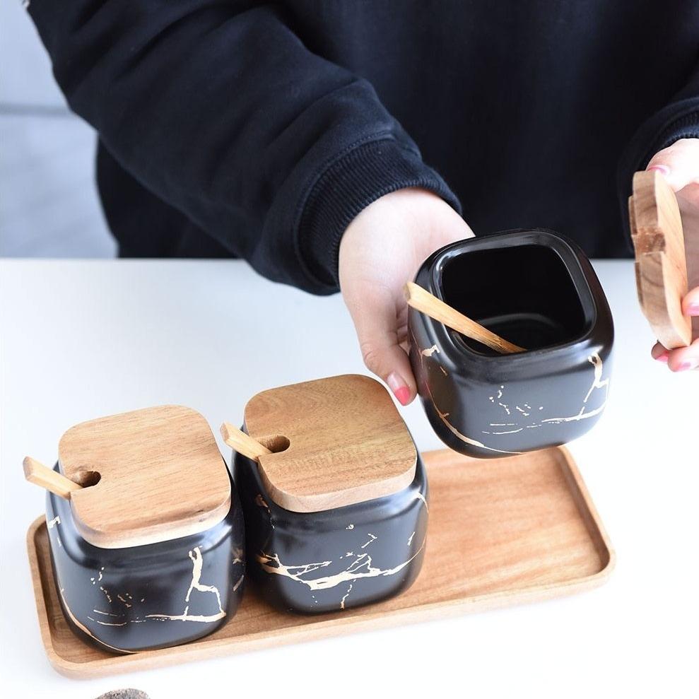 Maci 8-Piece Spice Ceramic Jar With Wooden Lid set on a wooden tray, perfect for table or pantry spice storage.