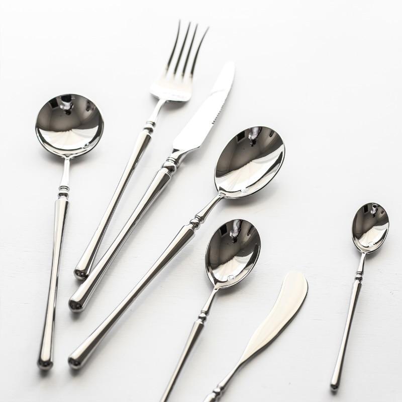 Zina Flatware Set 24-Piece (Polished) shown in mirror-finished stainless steel on a white surface.