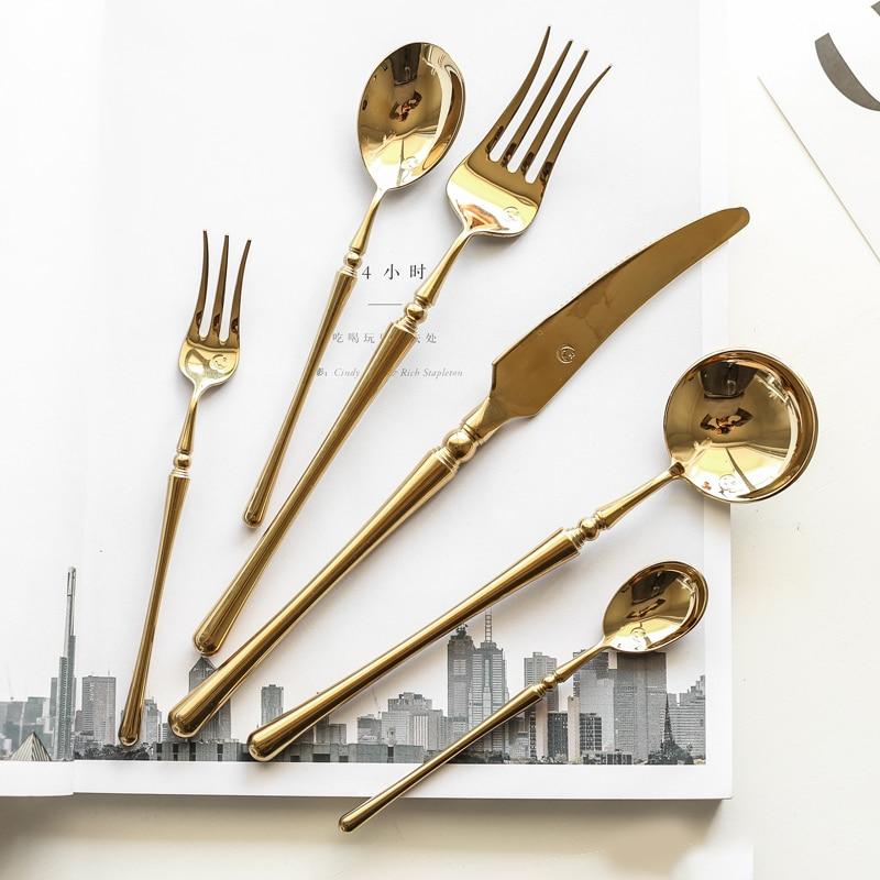Zina Flatware Set 24-Piece (Polished) with mirror-finished utensils on open book