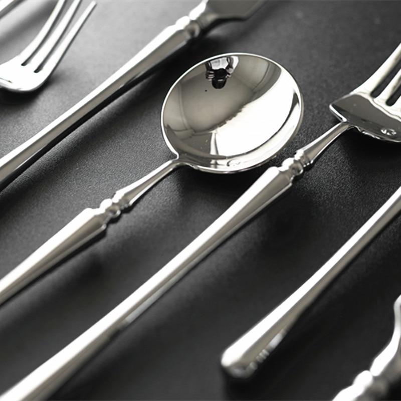Zina Flatware Set 24-Piece (Polished) in gleaming stainless steel showcasing modern design on black background