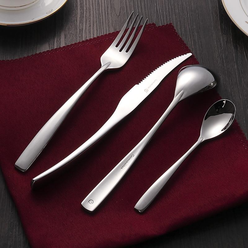 Talia Shiny Silver Flatware 24-Piece Set displayed on a red napkin, showcasing curved detail and shiny polished finish.